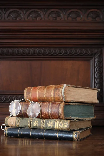 old books piled on an old furniture