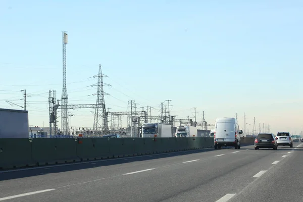 highway with trucks and electric  trellis on the background