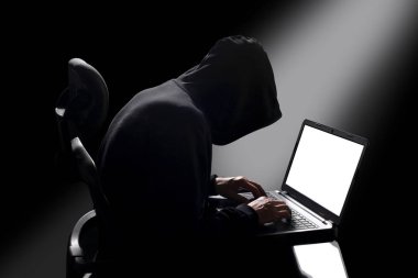 hacker sitting at the desk with clipping path around the subject and copy space for your text