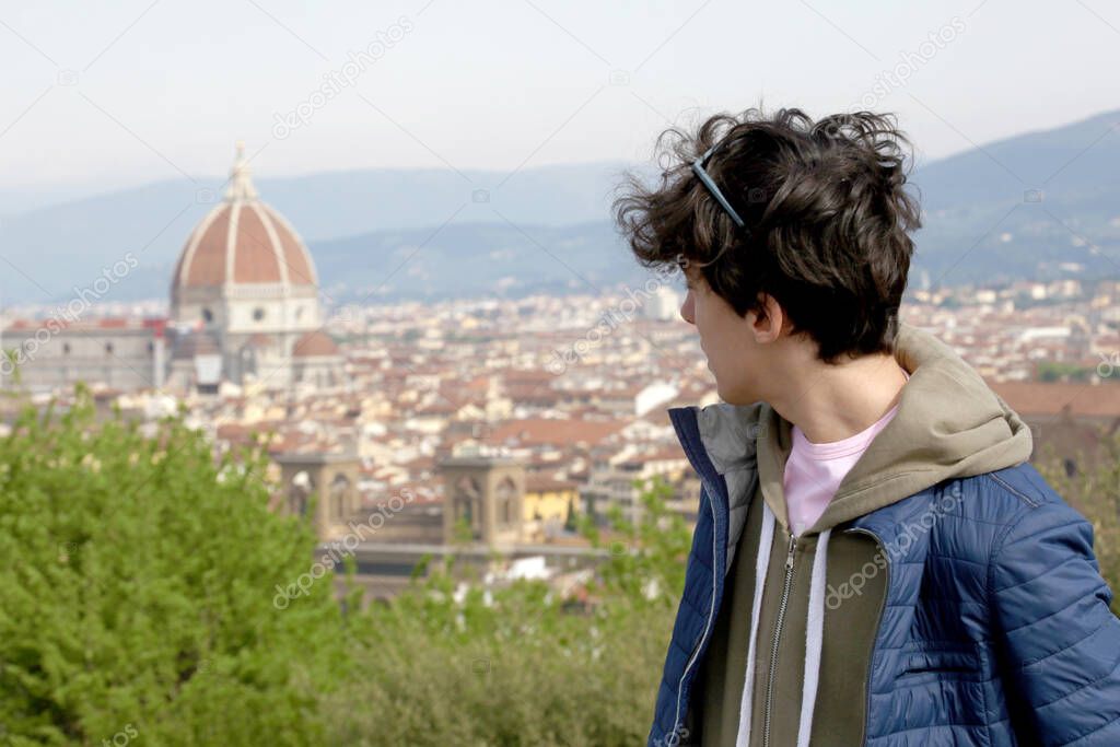  male teenager with the city of Florence on the background with copy space for your text