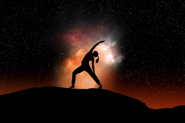 woman silhouette in yoga position against a black starry sky with copy space for your text