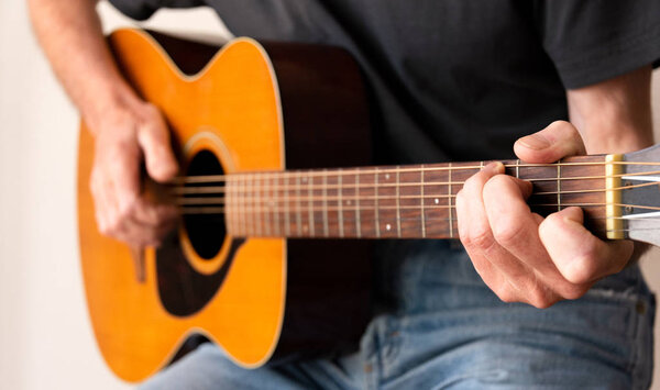 Man playing an Acoustic Guitar