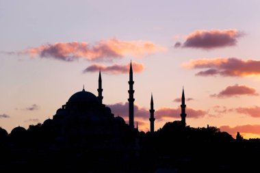 İstanbul'da gün batımında gökyüzünde cami konturu