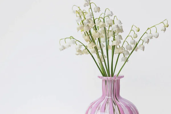 stock image lily of valley flowers bouquet in vase with white wall