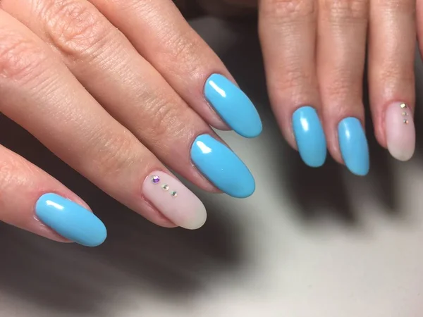 fashionable blue manicure with beige matte design and rhinestones