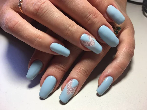 fashionable blue manicure with white lace and triangular hole