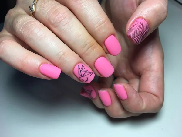fashionable matte pink manicure with abstraction on short nails