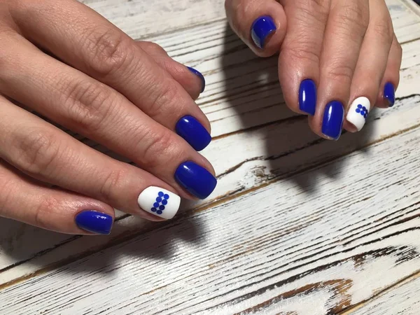 fashionable blue manicure with a white matte coating