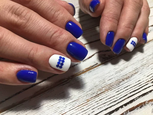 fashionable blue manicure with a white matte coating