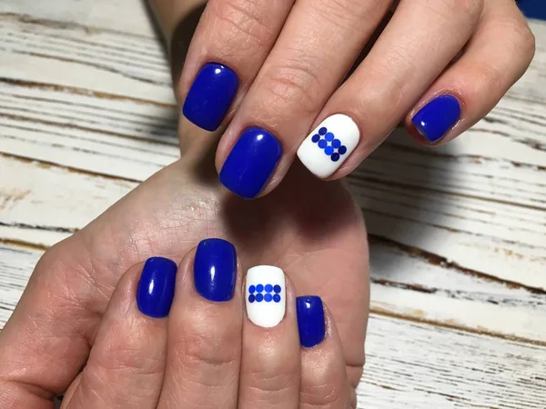 fashionable blue manicure with a white matte coating