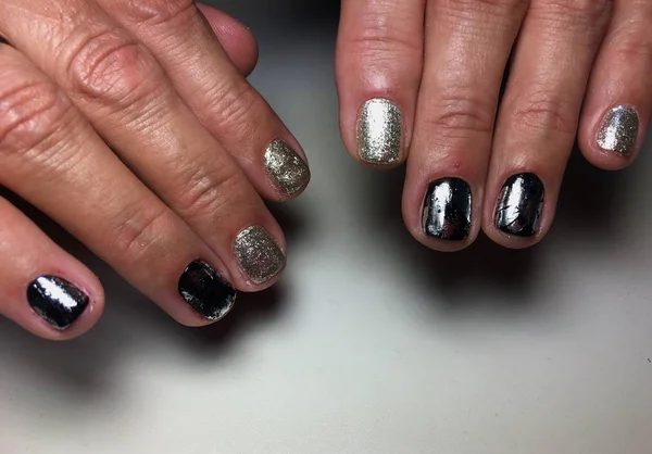 Fashionable silver manicure with black foil on short nails