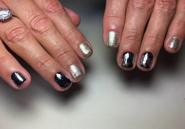 Fashionable silver manicure with black foil on short nails