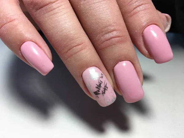 delicate pink manicure with fashionable design on long nails