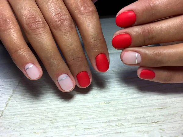 fashionable red matte manicure with shiny silver ribbon