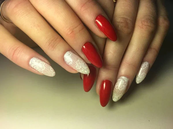 fashion red manicure with bright white design on long nails