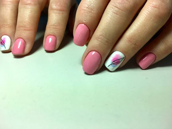 Fashion pink manicure on a textural background