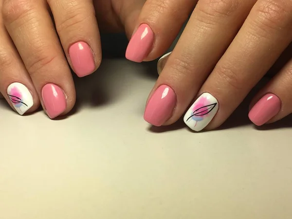 Fashion pink manicure on a textural background