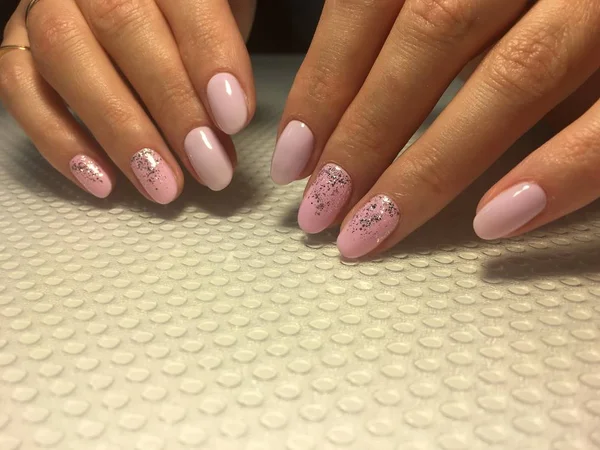Stylish pink manicure with a fashionable shiny design, — Stock Photo, Image