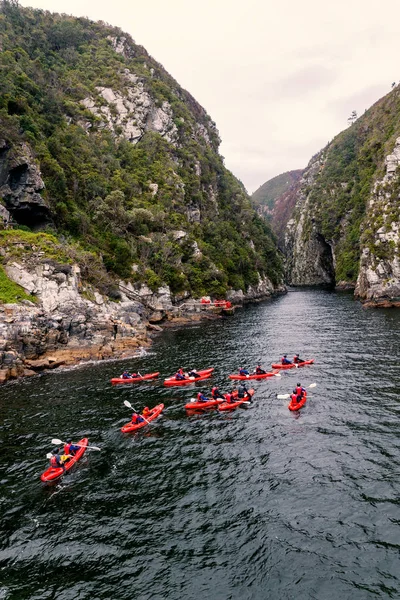Group kayaking in river canyon in Knysna, South Africa