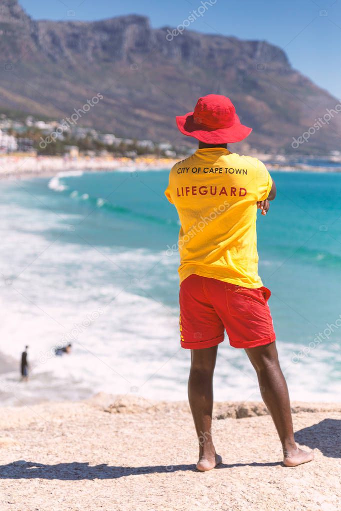 Cape Town lifeguard watching famous Camps Bay beach with turquoise water