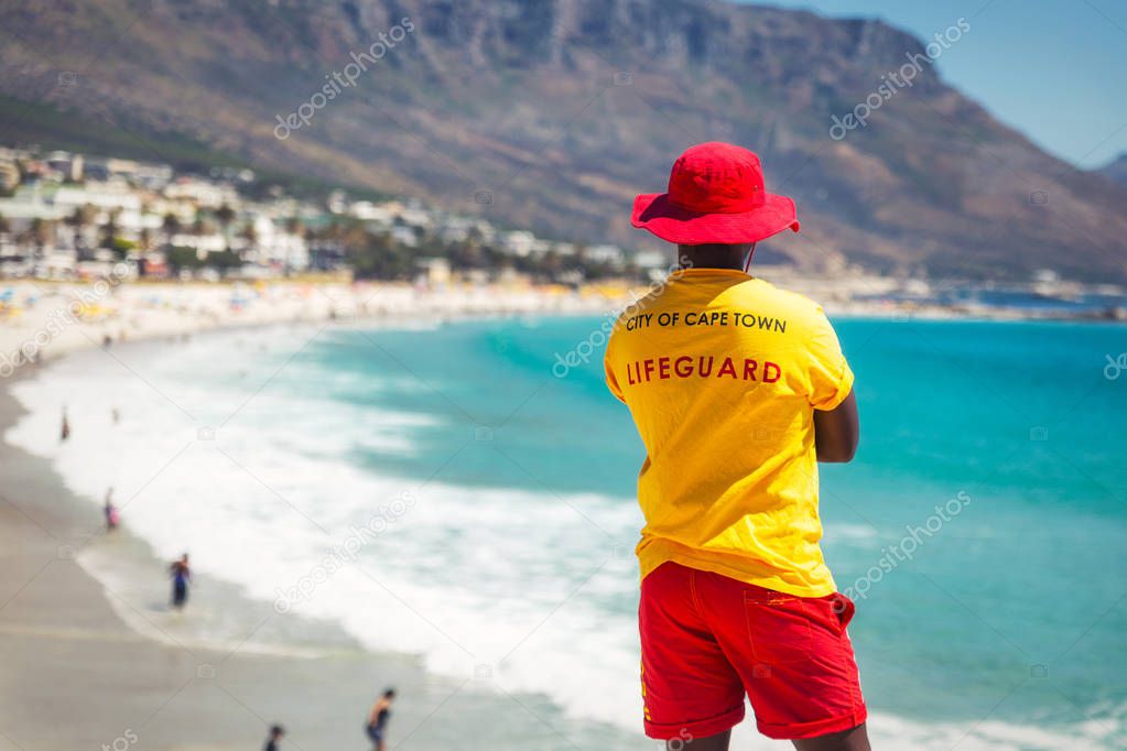 Cape Town lifeguard watching famous Camps Bay beach with turquoise water