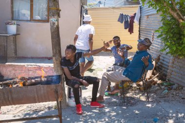 CAPE TOWN, SOUTH AFRICA - NOVEMBER, 2018: Local people in Imizamo Yethu township in Hout Bay, Cape Town clipart