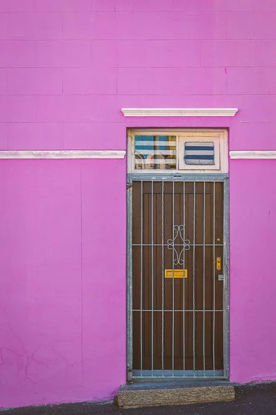 Colorful purple facade and old door of house in Bo Kaap area, Cape Town