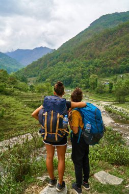 friends enjoying a break from hiking in Nepal Annapurna region  clipart