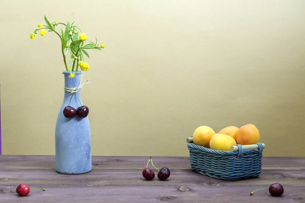 Apricots Wicker Basket Cherries Wooden Table Vase Wildflowers Beige Background — Stock Photo, Image