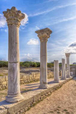 Surviving columns of Basilica in Chersonesos in the Crimea. on blue sky background clipart