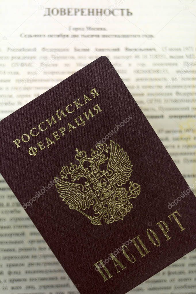 Russian documents. Notarial form of power of attorney to another person. Russian passport lies on top. Blurred background