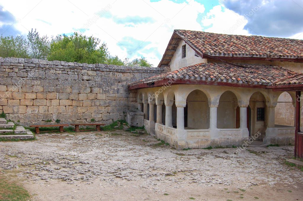 Old houses with tiled roofs. Chufut Kale, a cave city in Crimea from the 5th century. View from the yard
