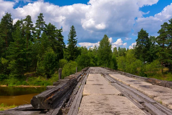 Old bridge over the river in the forest — Stock Photo, Image