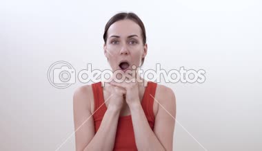 Çiğneme kasları için rahatlatıcı egzersiz yaparak esmer bir kadın portresi. Beyaz arka plan üzerinde izole.