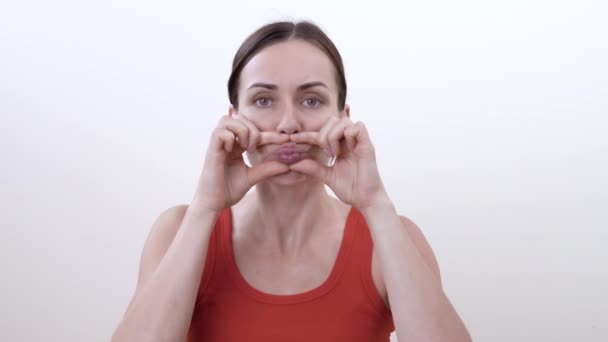 一个黑发女人的肖像做面部运动 以塑造嘴唇 减少下垂的皮肤和色调你的嘴唇的肌肉 — 图库视频影像