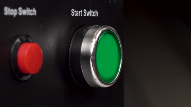 Closeup of two buttons in the frame. Green start switch and red stop switch buttons. Finger press the green start switch button. — Stock Video