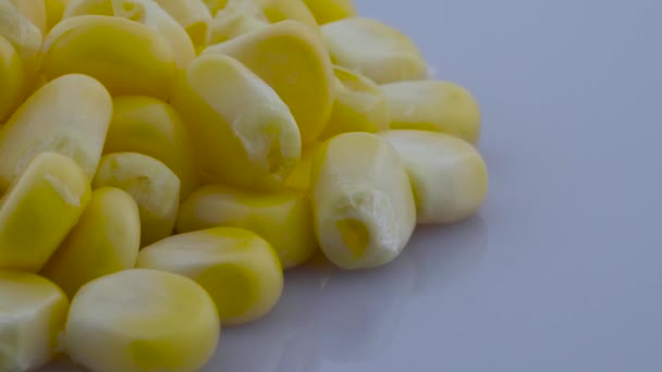 Super close macro of corn kernels rotating on the turntable. Isolated on the white background. — Stock Video