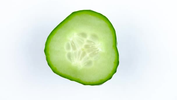 Top view from above of a fresh green cucumber. Cross section. Rotating on the turntable isolated on the white background. Close-up. Macro. — Stock Video