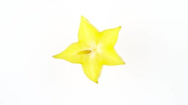 Üstten görünüm olgun carambola meyve dilim. Kesit. Beyaz arka plan üzerinde izole pikap üzerinde döner. Yakın çekim. Makro.