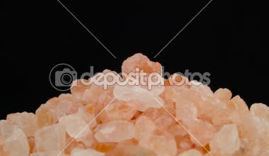 Makro pembe Himalaya tuz kristallerinin üst kısmı çekim. Turntable döner. Siyah arka plan üzerine izole. Yakın çekim.