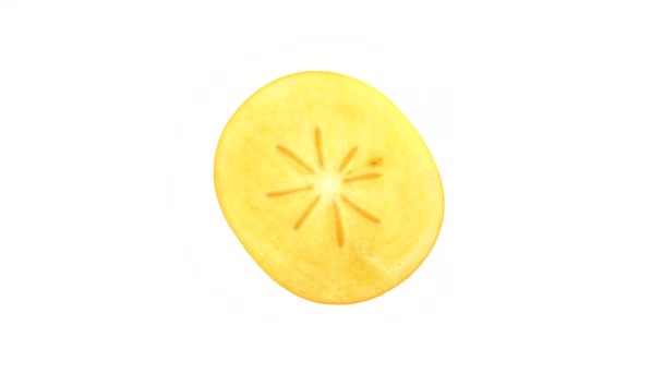 Tvärsnitt av en persimon frukten. Roterande på skivtallriken. Isolerad på den vita bakgrunden. Närbild. Makro. — Stockvideo