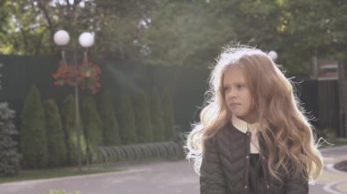 Sevimli küçük sarışın kız dışında standları ve sola doğru görünüyor. O elini onun önünde tutan ve parmaklarını arıyorum başlar, sonra bir yandan bir şeyler ayarlar.