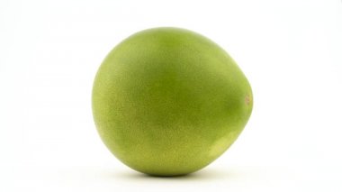 Bir büyük shaddock pomelo meyve. Su damlaları döndürme sırasında görünür. Beyaz arka plan üzerinde izole. Yakın çekim. Makro.