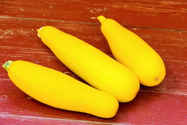 木製の表面に3つの大きな黄色のズッキーニ — ストック写真