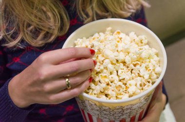 Kadın eli yakın, patlamış mısır alıyor..