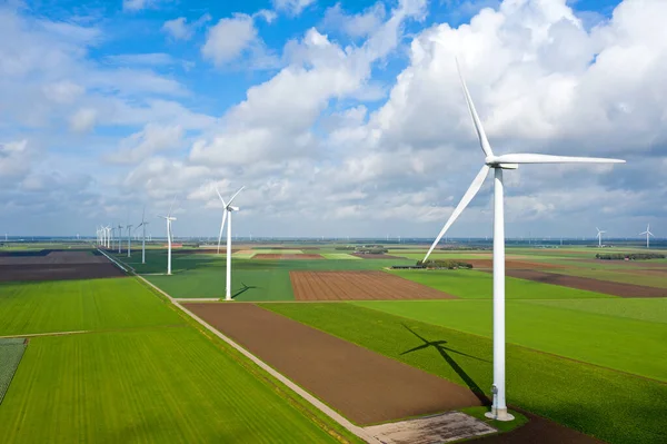 Aerial from a dutch landscape with windturbines, meadows and beautiful skies