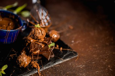 Çikolatalı pralinler ve erimiş çikolatalı parçalar.