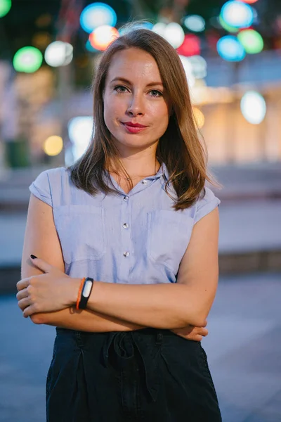 Şehirde poz beyaz beyaz bir kadın portresi. O profesyonel ofis kıyafet ve gülümseyen giymiş 