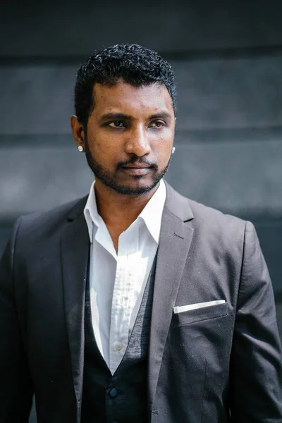 Portrait of a cool Indian Asian man  in the day. He is in a casual suit