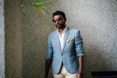 Serin bir portresi Hint Asya adam gün. O sıradan bir takım elbise ve güneş gözlüğü.. 